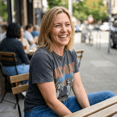 Happy woman smiling at a cafe, embodying the confidence of healthy skin and nails with Kerassentials
